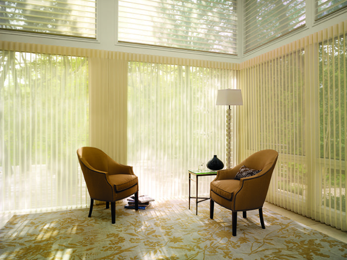 a glass walled room with two chairs