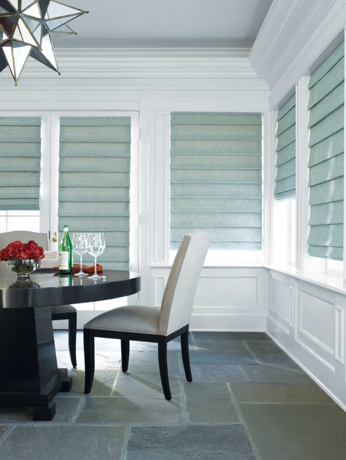 dining space, surrounded by windows with shades