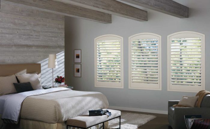 furnished bedroom with shuttered windows