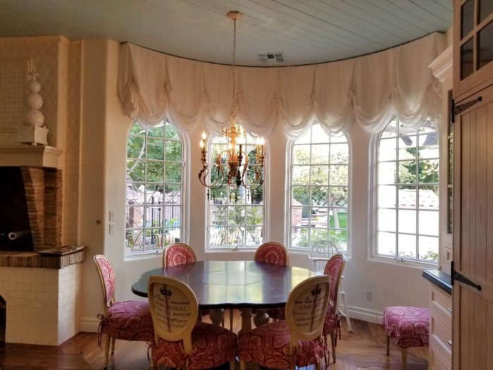 circular dining space with multiple window panels