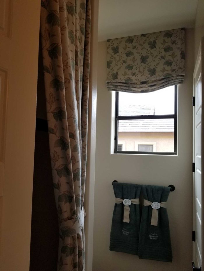 hallway with small lookout window and doorway curtain