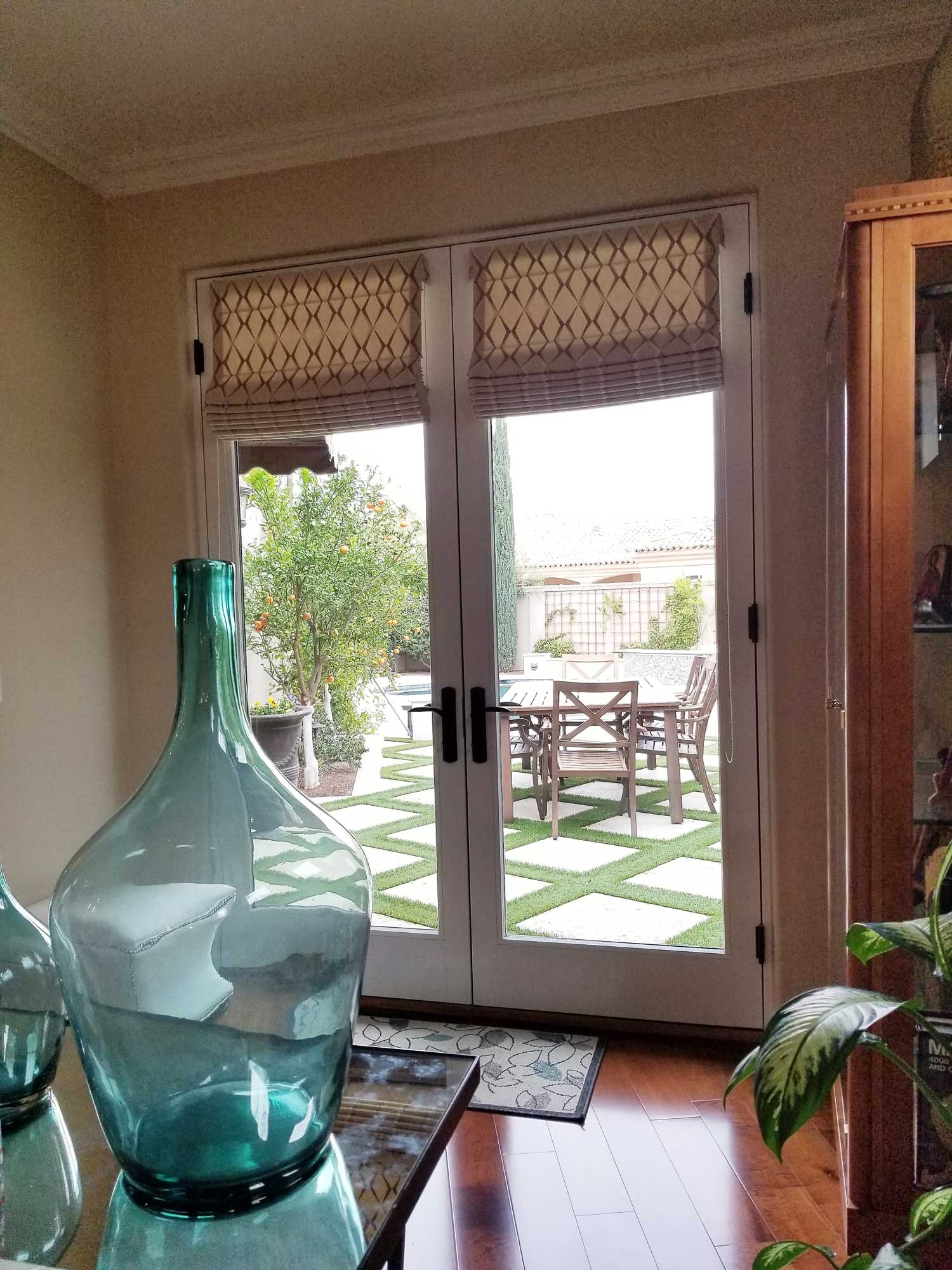 window from living space opening into a patio with dining table and chairs