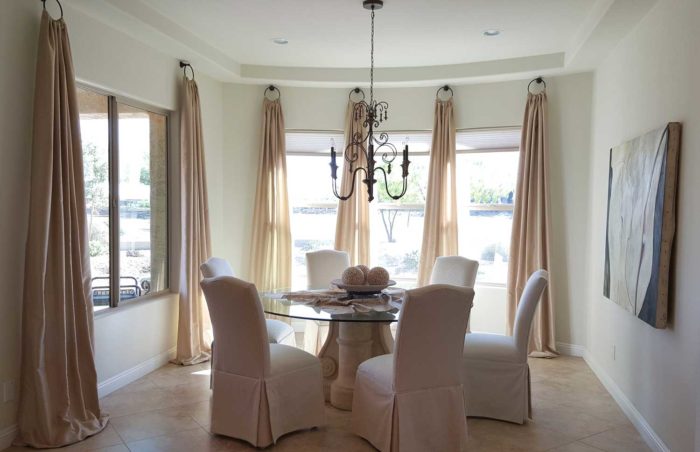 well-furnished dining space with large windows