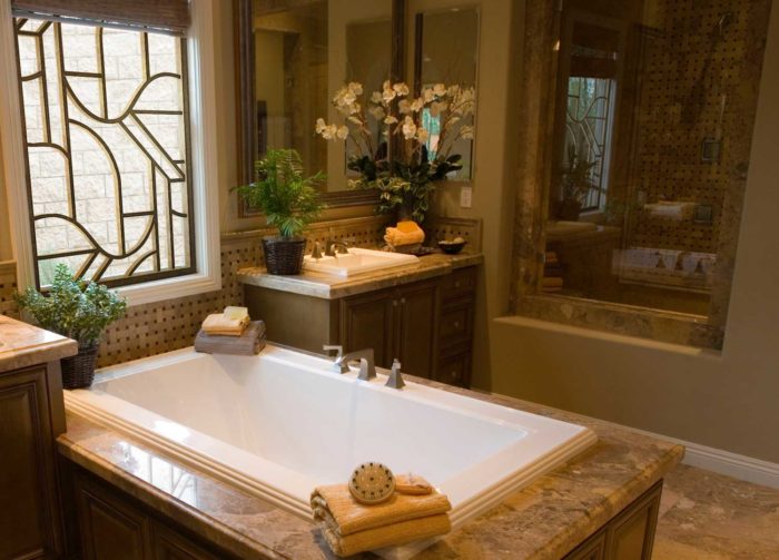 bathtub set in marble flooring, in a decorated bathroom