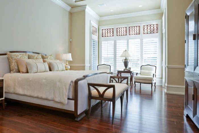 bedroom with cot, chairs and window with shutters