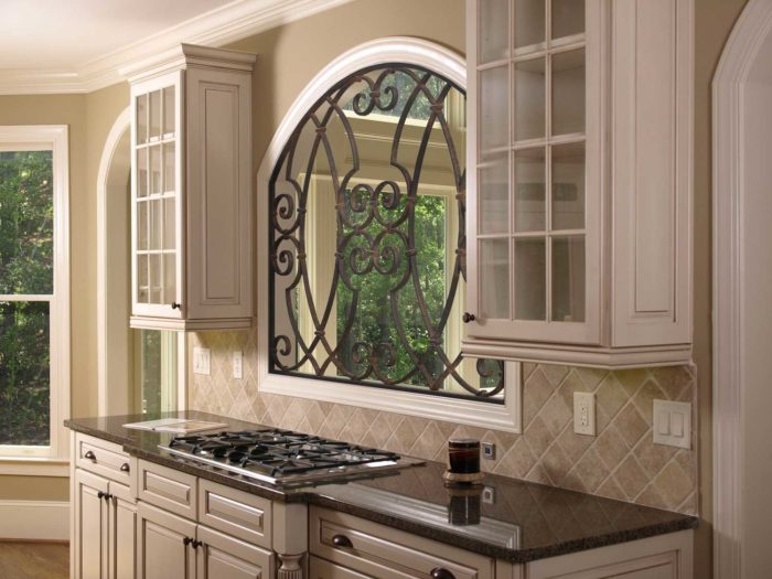 kitchen space with stove, shelves and windows