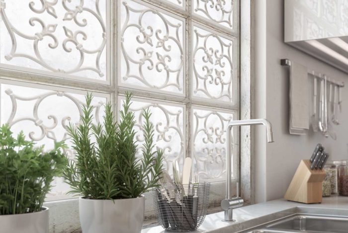 glass-paned window with metalwork above a kitchen sink